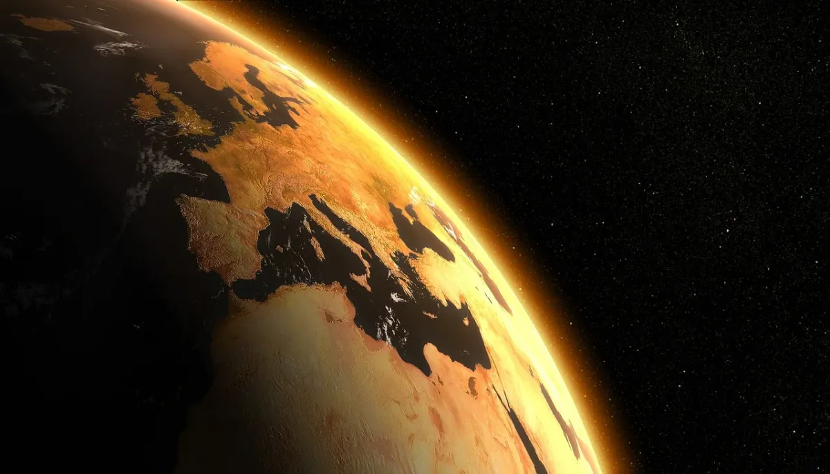 Glob ziemski otoczony płomieniami, symbolizujący kryzys klimatyczny i pilną potrzebę działań na rzecz ochrony środowiska.